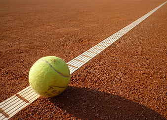 Tennis Ball On Clay Court Line