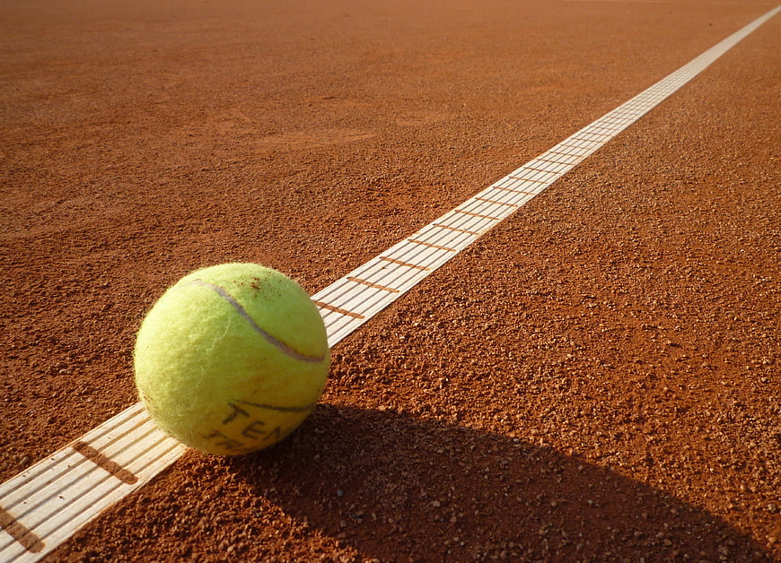 Tennis Ball On Clay Court Line