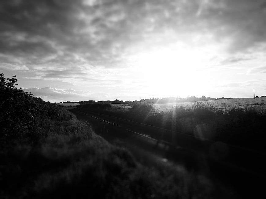 Dramatic Black and White Rural Road at Sunset