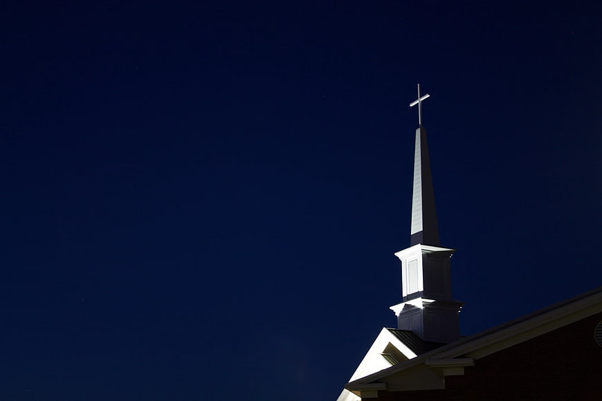 Church Steeple with Cross Against Deep Blue Night Sky