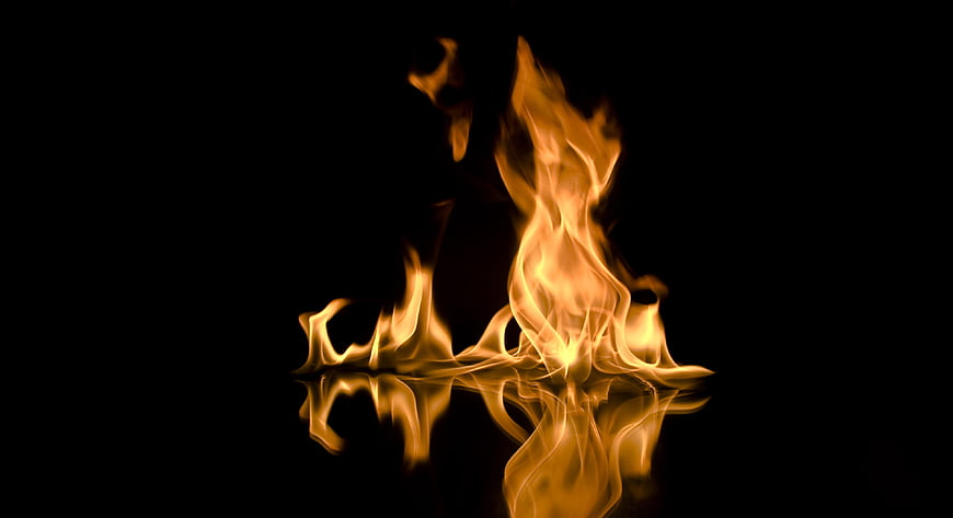 Vibrant Orange Fire Flames with Reflection on Black Background