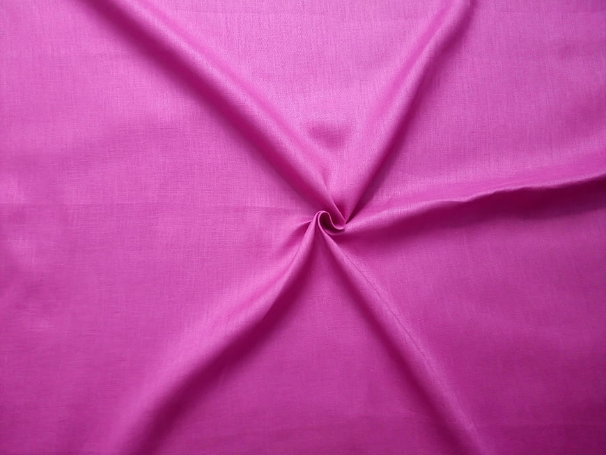 Close-up of textured pink fabric with central swirl