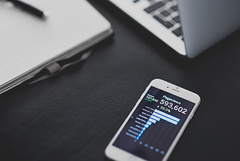 Smartphone displaying pageviews analytics on a dark desk