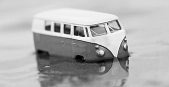 Vintage VW Bus Toy Model in Water Reflection