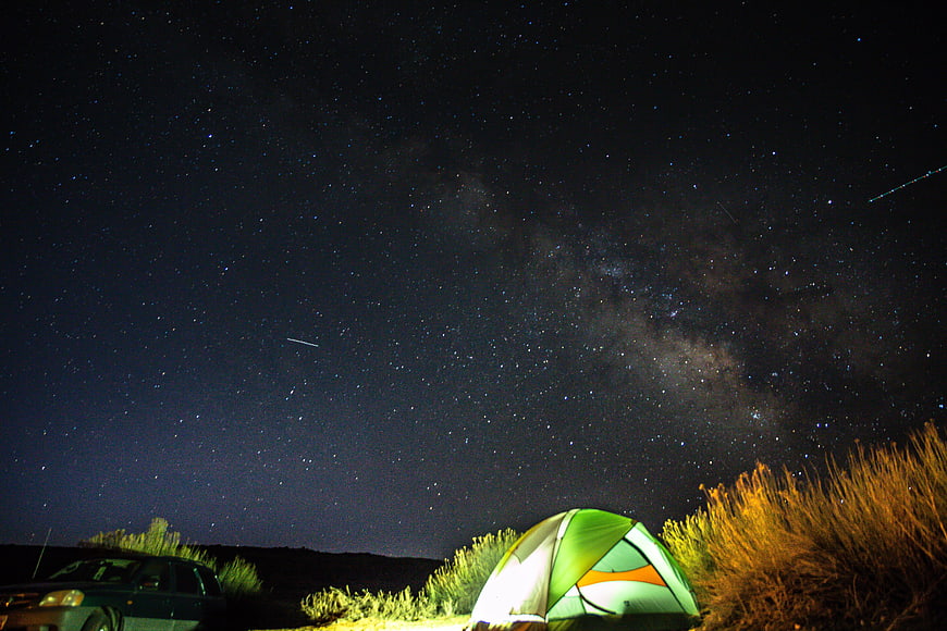 Camping under the Milky Way with a car and tent