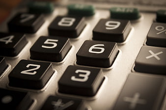 Close-up of vintage calculator keypad with black buttons