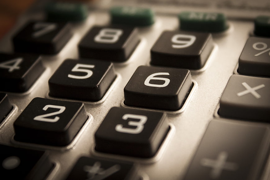 Close-up of vintage calculator keypad with black buttons