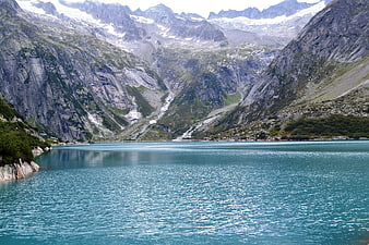 Turquoise Alpine Lake Surrounded by Snowy Mountains
