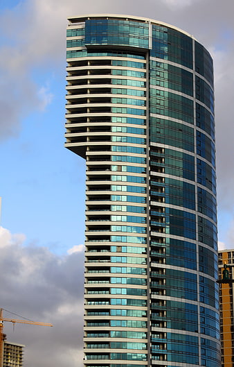 Modern Glass Skyscraper with Curved Facade and Balconies