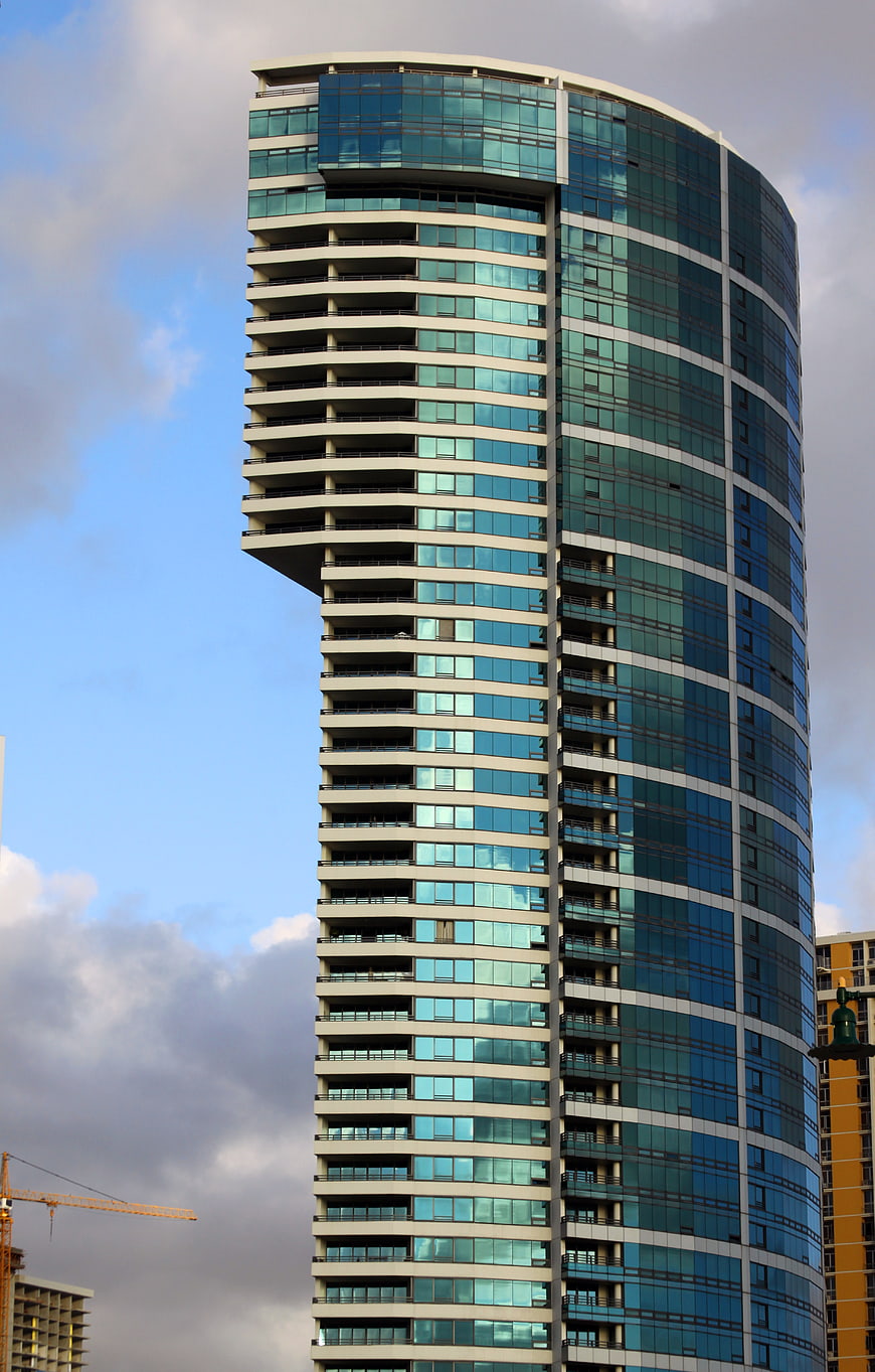Modern Glass Skyscraper with Curved Facade and Balconies