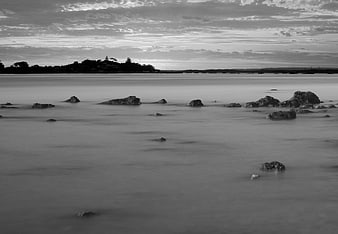 Black and white long exposure seascape with smooth water and rocks