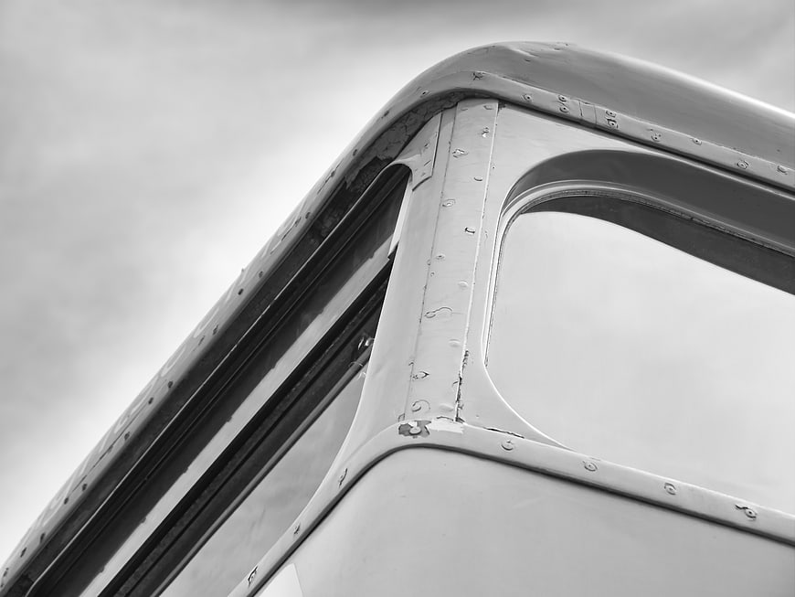 Close-up of vintage vehicle window frame in black and white