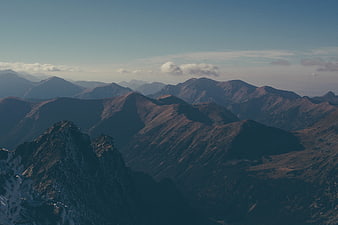 Majestic Mountain Range with Snow-Capped Peaks and Clouds