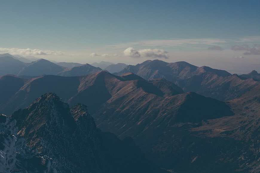 Majestic Mountain Range with Snow-Capped Peaks and Clouds