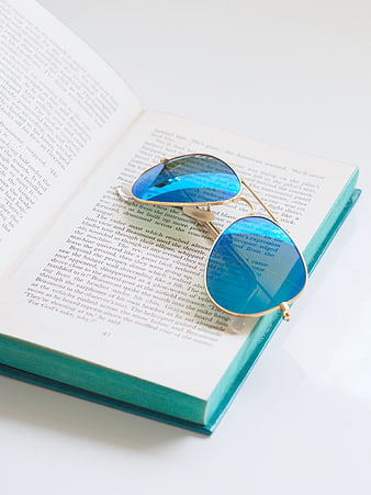 Blue Sunglasses on Open Book