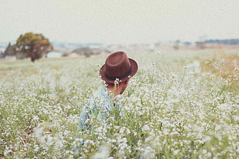 Man in Fedora Sitting in White Flower Field