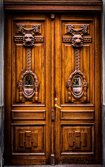 Ornate wooden double doors with carved lion heads