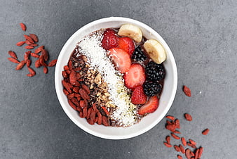 Overhead view of healthy acai bowl with berries and goji berries