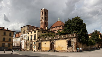 Historic Italian Church Square with Dramatic Cloudy Sky
