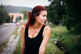 Redhead Woman in Black Top Looking Away Outdoors