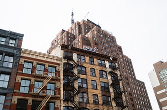 Low Angle View of Urban Brick Buildings with Fire Escapes