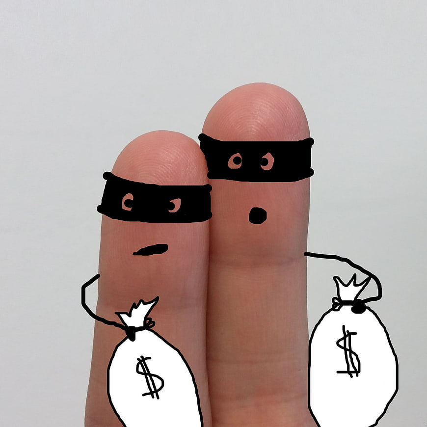 Finger puppets dressed as thieves holding money bags