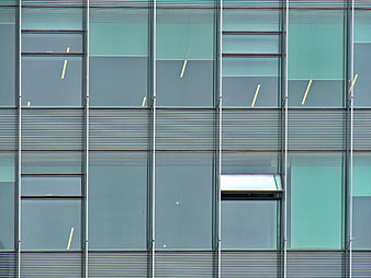 Modern Glass Office Building Facade with Abstract Geometric Patterns