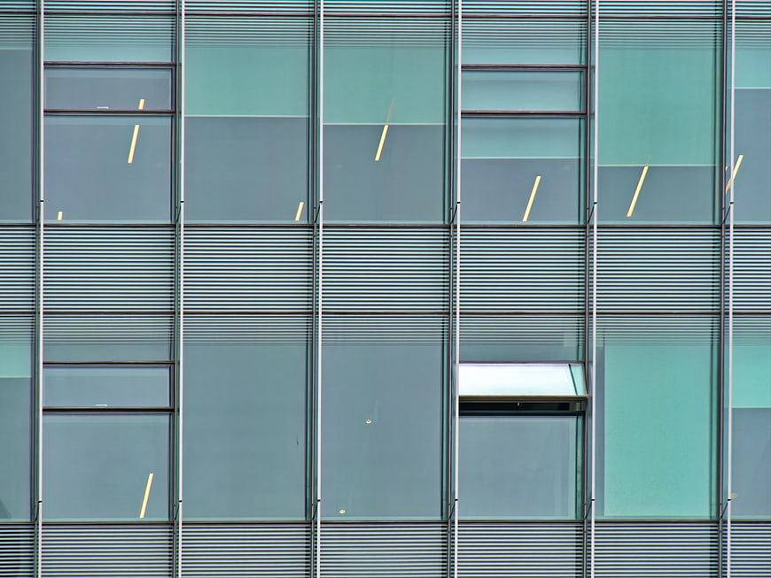 Modern Glass Office Building Facade with Abstract Geometric Patterns