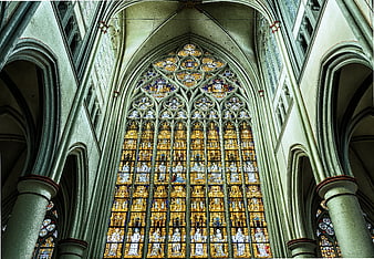 Gothic Cathedral Interior with Golden Stained Glass Window