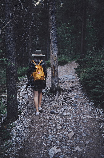 Woman Hiking on Forest Trail with Yellow Backpack