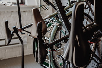 Close-up of bicycle saddles and frames in a workshop