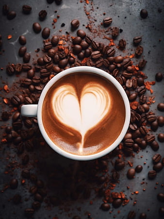 Top View of Heart Latte Art in White Cup with Coffee Beans