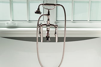 Chrome Bathtub Faucet And Handheld Shower Head In Modern Bathroom