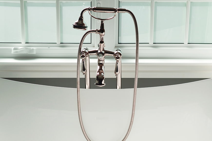 Chrome Bathtub Faucet And Handheld Shower Head In Modern Bathroom