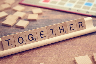 Scrabble Tiles Spelling Together on Wooden Rack
