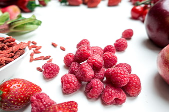 Fresh Raspberries and Red Fruits on White Background