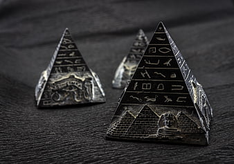 Antique Egyptian Pyramid Souvenirs on Dark Wood Surface