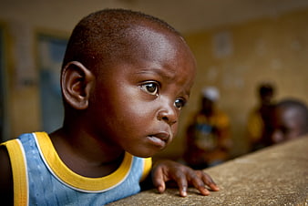 Close-up portrait of young African boy looking away