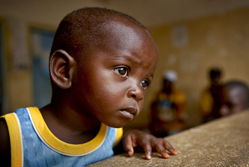Close-up portrait of young African boy looking away