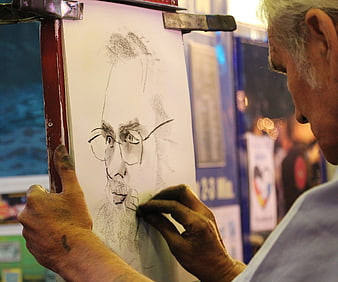 Senior artist sketching charcoal portrait on easel