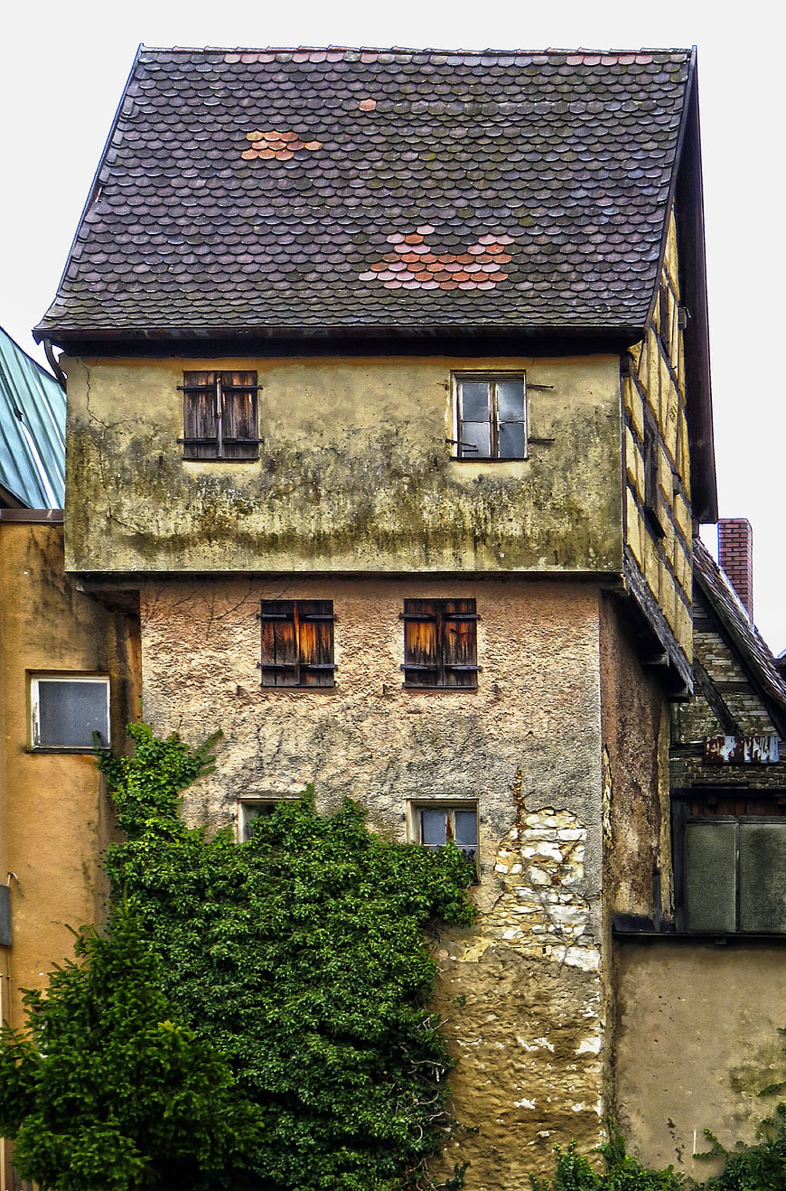 Old historic half-timbered house facade with ivy