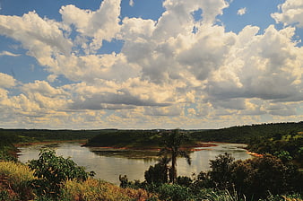Wide River Landscape with Dramatic Clouds and Lush Green Hills