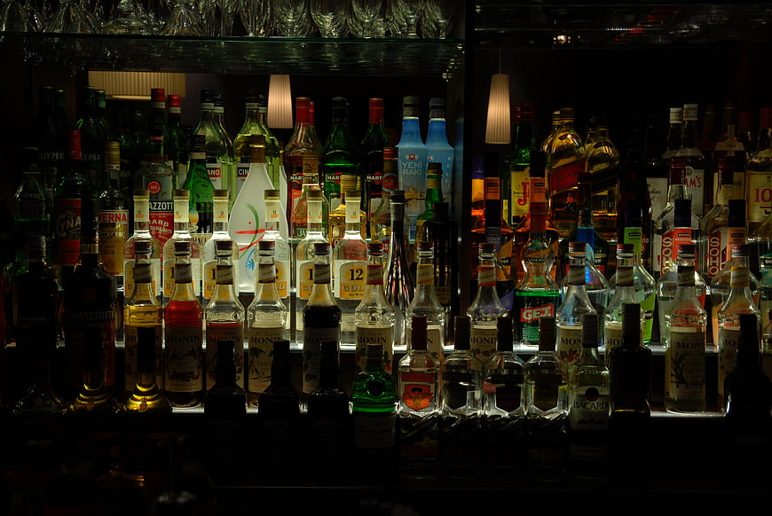 Backlit Bar Shelves with Assorted Liquor Bottles