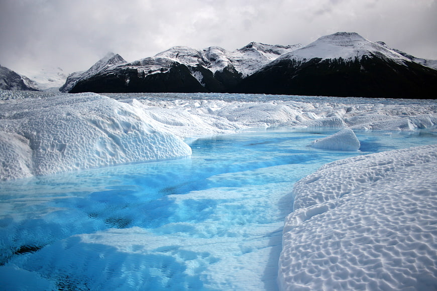 Vibrant Blue Glacier Lagoon in Patagonia with Snowy Mountains