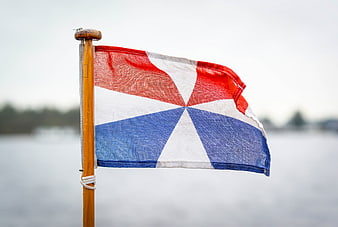 Dutch Naval Flag Waving on Wooden Pole