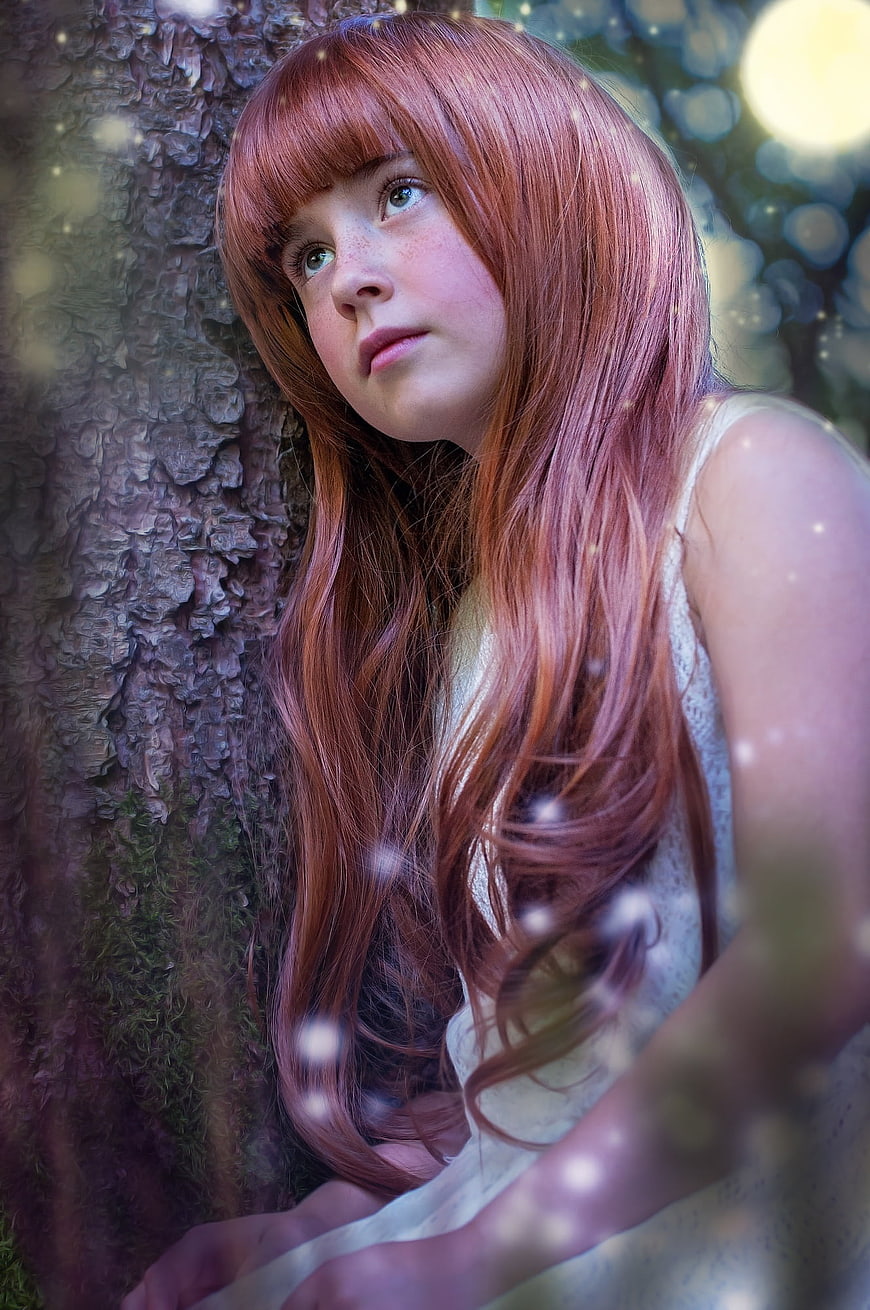 Dreamy Portrait of Girl with Red Hair in Forest