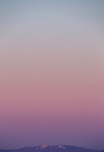 Minimalist Pink and Purple Sky Gradient Over Snowy Mountain Peak