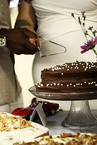 Couple Cutting Chocolate Wedding Cake with Sprinkles