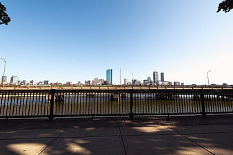City Skyline View Across River with Bridge and Blue Sky