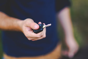 Hand Holding Car Key Fob Outdoors